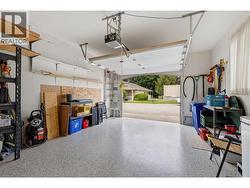 Attached garage featuring durable epoxy-coated flooring with transferable warranty. -