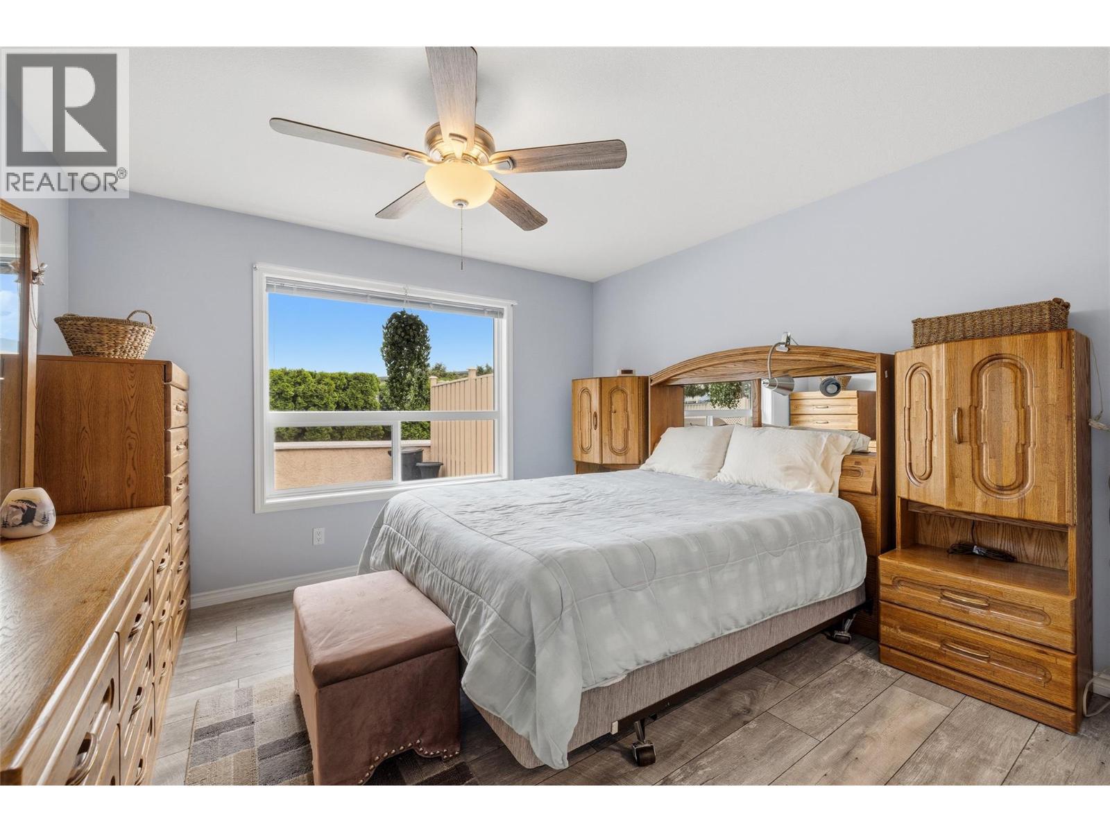 Generous primary bedroom with updated flooring and ceiling fan. - 2250 Louie Drive Unit# 69, Westbank, BC - Indoor Photo Showing Bedroom