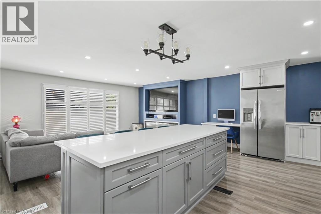 Spacious kitchen island with a white countertop and grey cabinetry - 44 Oakhurst Crescent, Kitchener, ON - Indoor Photo Showing Kitchen