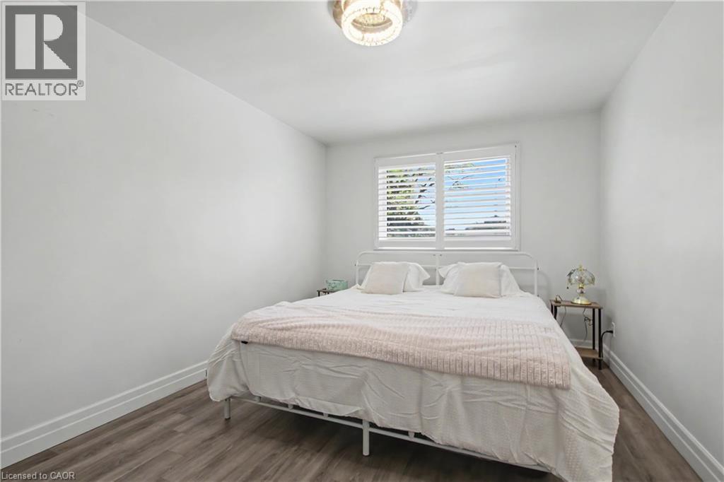 Bright room featuring wood-finish flooring and white baseboards - 44 Oakhurst Crescent, Kitchener, ON - Indoor Photo Showing Bedroom