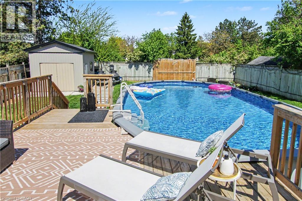 Wood deck with an above-ground pool, providing a prominent outdoor living space - 44 Oakhurst Crescent, Kitchener, ON - Outdoor With Above Ground Pool With Deck Patio Veranda With Backyard