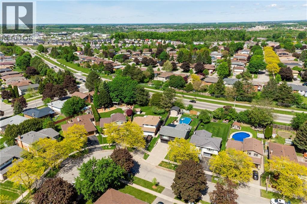 Aerial perspective of a residential area featuring numerous detached homes with varied rooflines and extensive tree coverage - 44 Oakhurst Crescent, Kitchener, ON - Outdoor With View