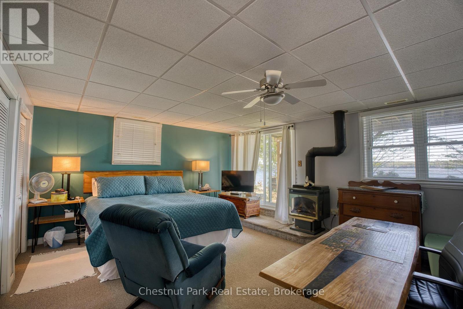 156 Miller Lake Shore Road, Northern Bruce Peninsula, ON - Indoor Photo Showing Bedroom With Fireplace