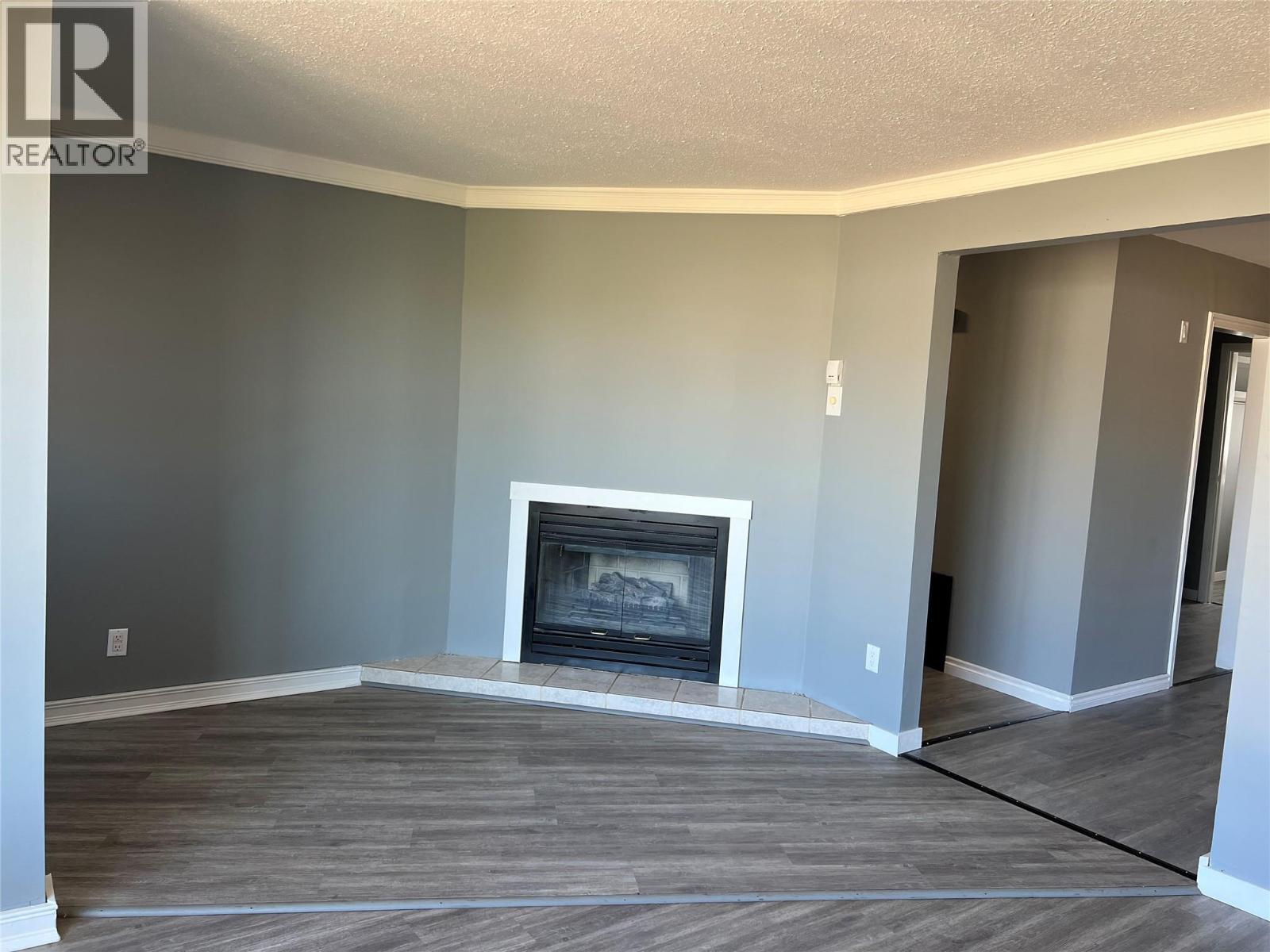 505 97A Avenue, Dawson Creek, BC - Indoor Photo Showing Other Room With Fireplace