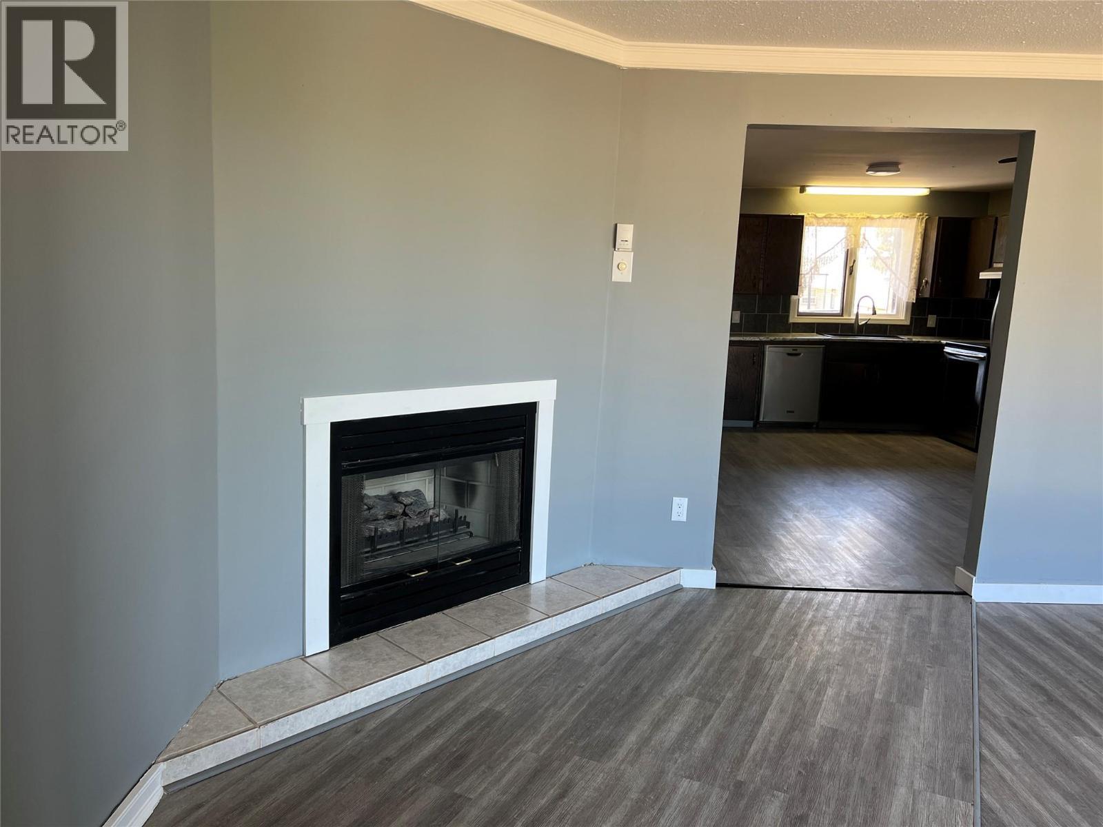 505 97A Avenue, Dawson Creek, BC - Indoor Photo Showing Living Room With Fireplace