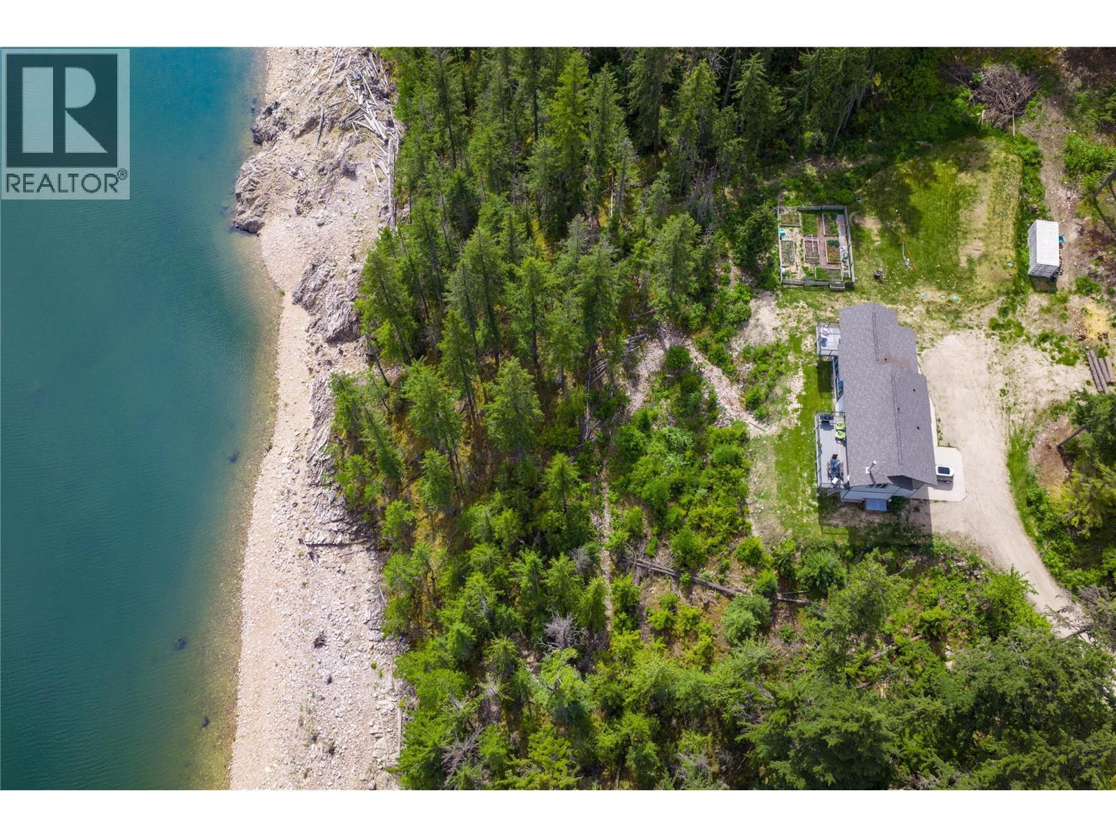 Drone Photo of Property that shows trail down to beachfront and Lake. - 8420 Highway 23 Highway S Lot# 1, Revelstoke, BC - Outdoor With Body Of Water With View
