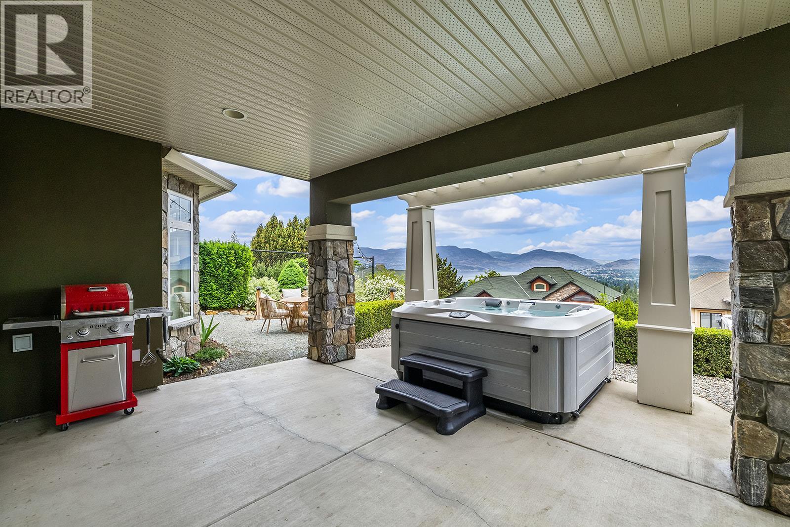 Lower Level Patio with Hot Tub - 629 Almandine Court, Kelowna, BC - Outdoor With Exterior