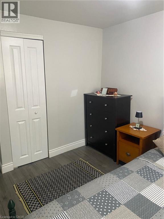 Bedroom featuring dark wood-style flooring and a closet - 58 Hazelglen Drive, Kitchener, ON - Indoor Photo Showing Bedroom
