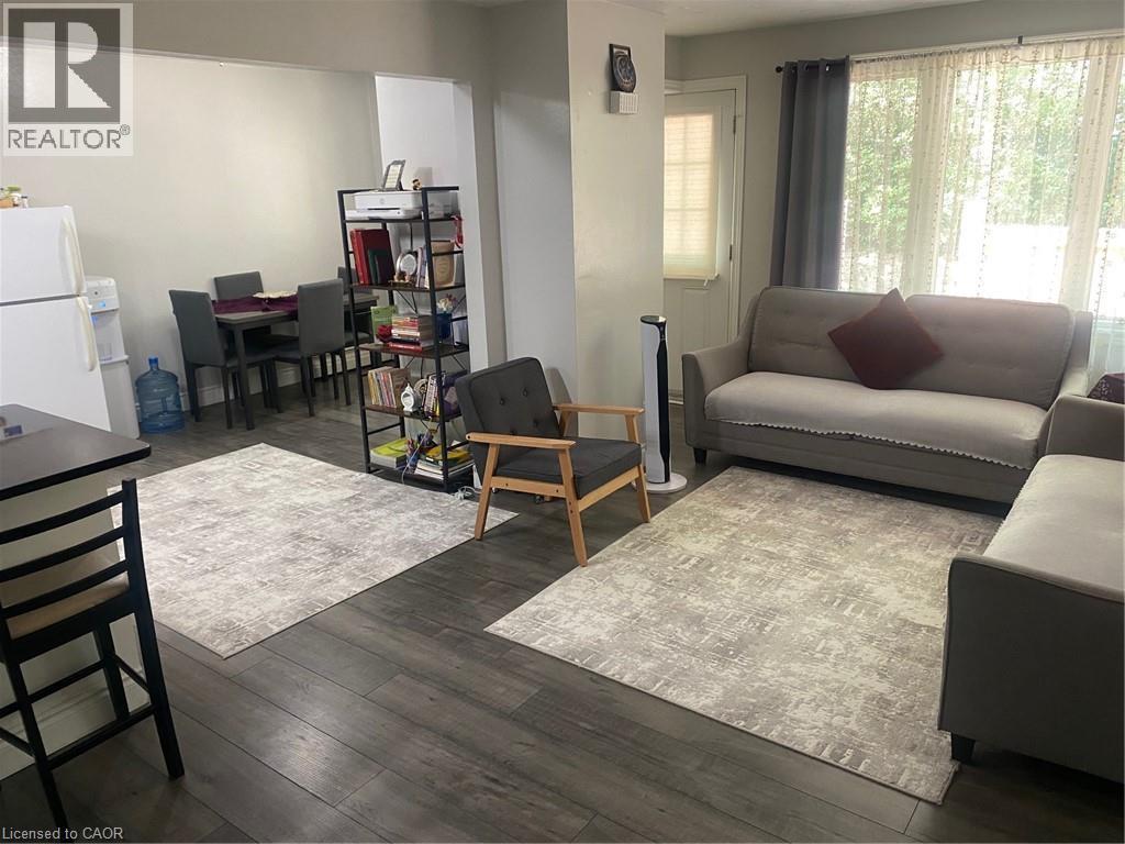Living room featuring dark wood finished floors - 58 Hazelglen Drive, Kitchener, ON