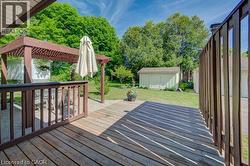 Spacious outdoor deck area featuring wood-finish decking and a complementary wood pergola -