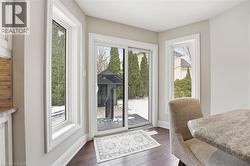 Doorway to outside featuring baseboards and wood finished floors -