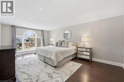 Bedroom with recessed lighting and dark wood-style flooring -