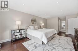 Bedroom with dark wood-type flooring and recessed lighting -