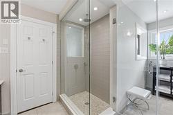 Full bathroom featuring vanity, a shower stall, light tile patterned floors, and recessed lighting -