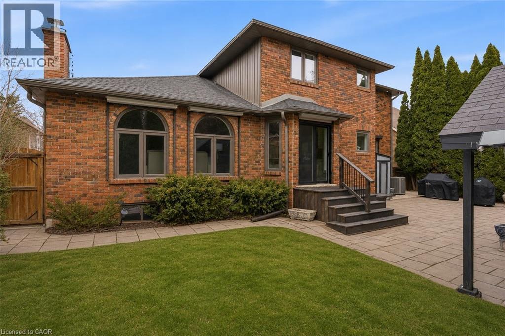 Red brick exterior with a multi-level design - 28 Deerview Avenue, Ancaster, ON