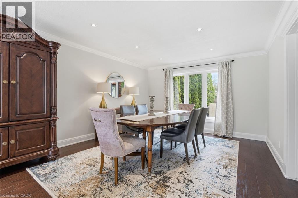 Dining room featuring dark wood-style floors, crown molding, and recessed lighting - 28 Deerview Avenue, Ancaster, ON
