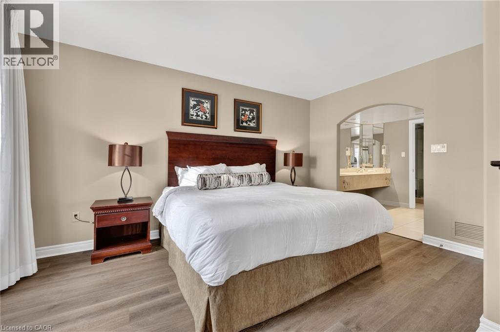 Bedroom with light wood-style floors and ensuite bathroom - 90 Highland Drive Unit# 2014/15, Simcoe, ON