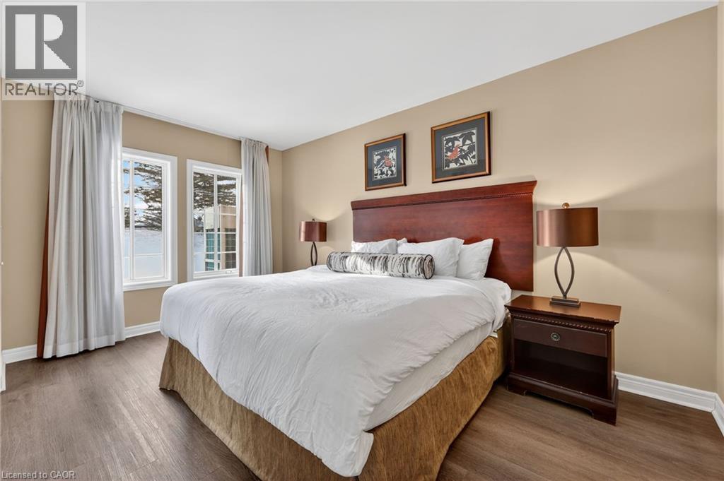 Bedroom with baseboards and dark wood-style floors - 90 Highland Drive Unit# 2014/15, Simcoe, ON