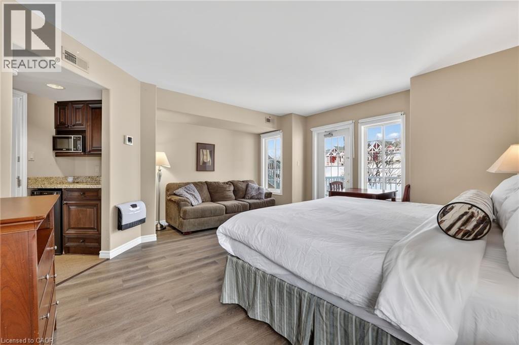 Bedroom featuring light wood finished floors and heating unit - 90 Highland Drive Unit# 2014/15, Simcoe, ON