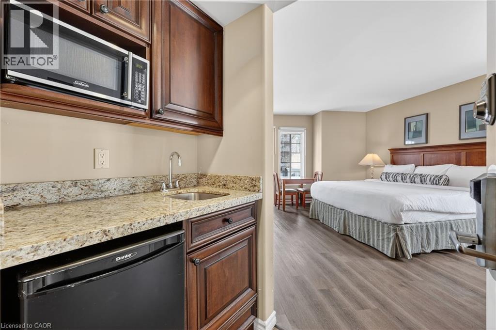Bedroom featuring light wood-style floors and a sink - 90 Highland Drive Unit# 2014/15, Simcoe, ON