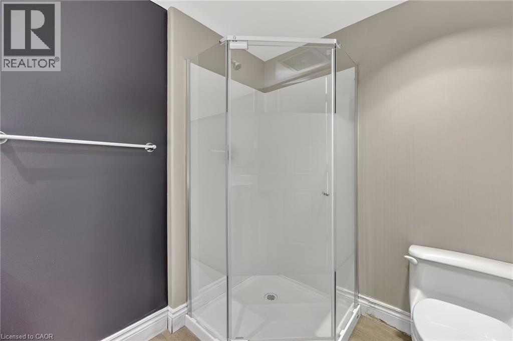 Full bathroom featuring a stall shower and baseboards - 90 Highland Drive Unit# 2014/15, Simcoe, ON