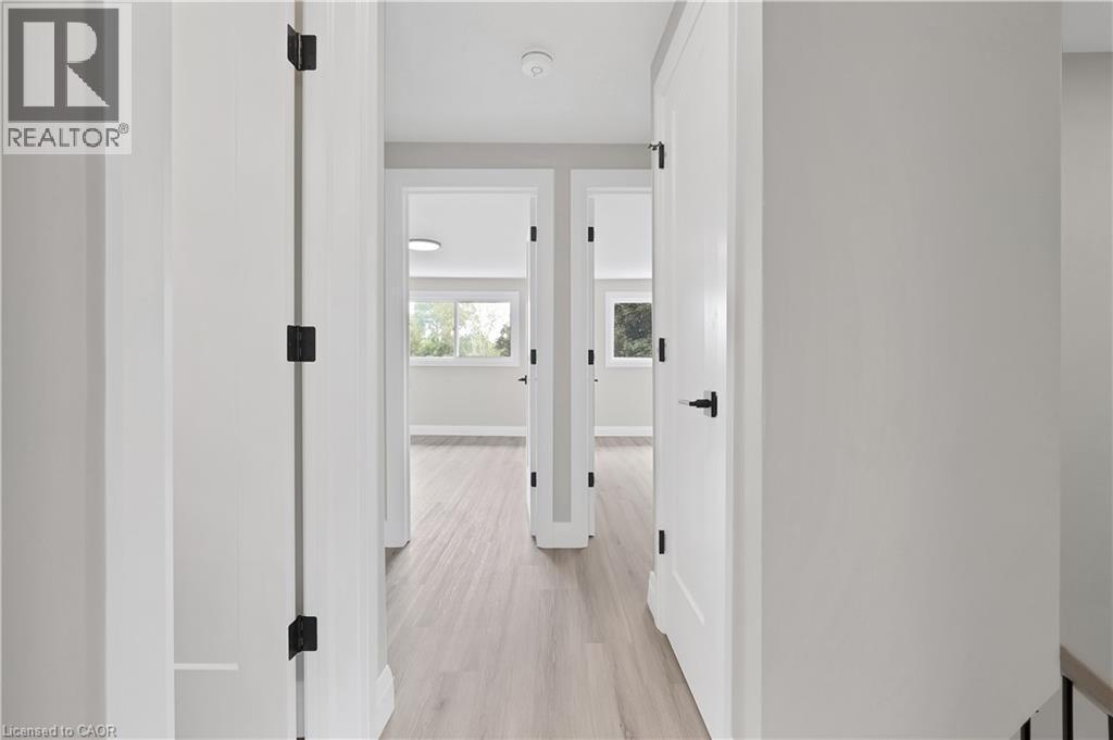 Hallway with light wood-finish flooring and white walls - 71 Blucher Street Unit# G, Kitchener, ON