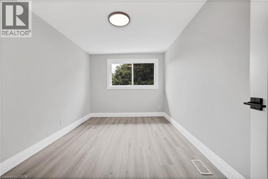 Light gray walls complemented by wood-finish flooring - 71 Blucher Street Unit# G, Kitchener, ON