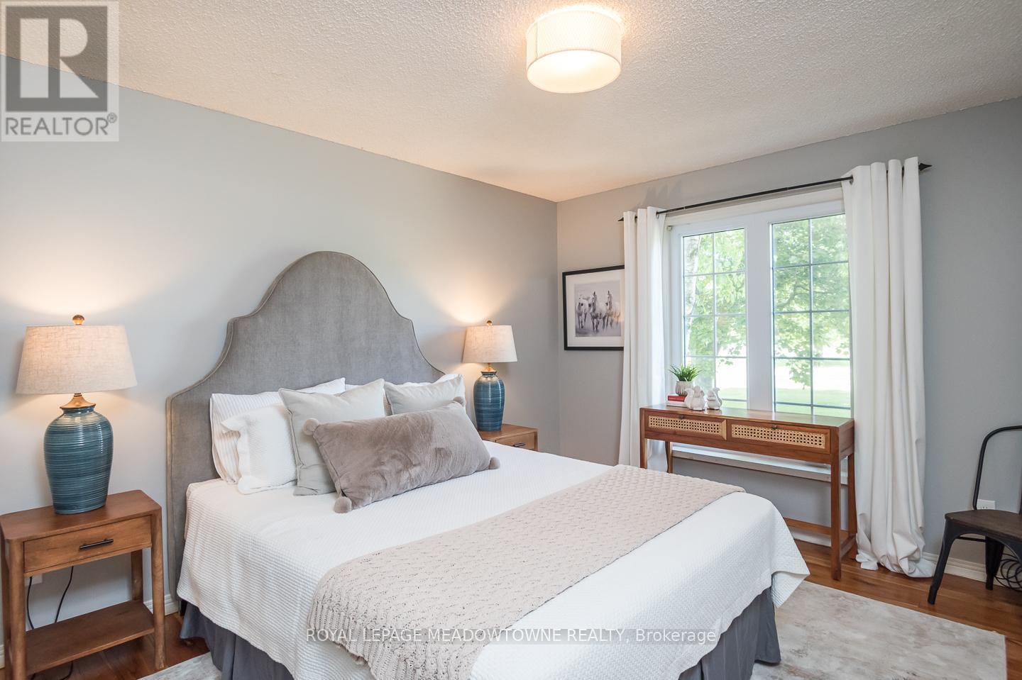 Main-floor bedroom, ideal for guests or family use - 11276 Amos Drive, Milton, ON