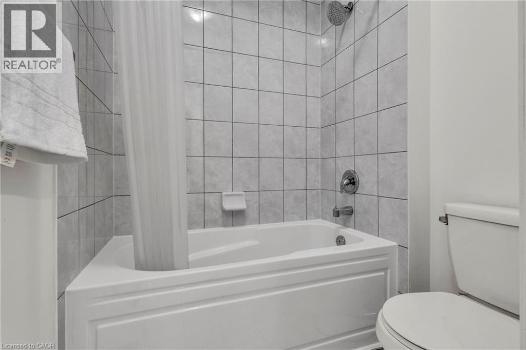Main Bathroom with vanity area and tub and toilet area separated - 101 Westfield Crescent, Waterdown, ON
