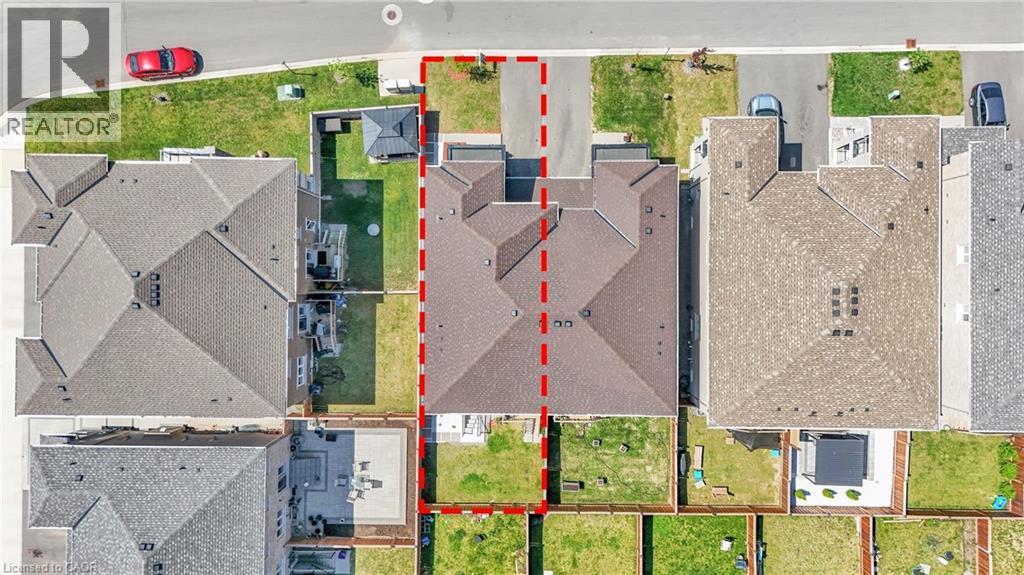 Aerial perspective showcasing a property with a brown shingle roof, a two-car driveway, and a fenced backyard - 101 Westfield Crescent, Waterdown, ON