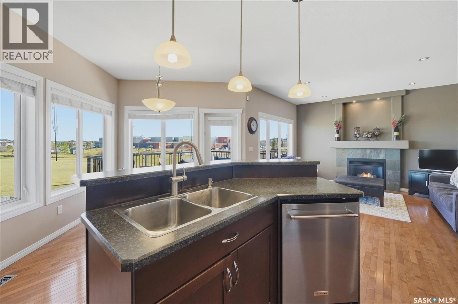 231 Willowgrove Boulevard, Saskatoon, SK - Indoor Photo Showing Kitchen With Fireplace With Double Sink
