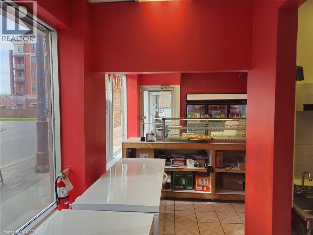 Commercial interior featuring red painted walls and tile flooring - 71 Ross Street Unit# 2, St. Thomas, ON