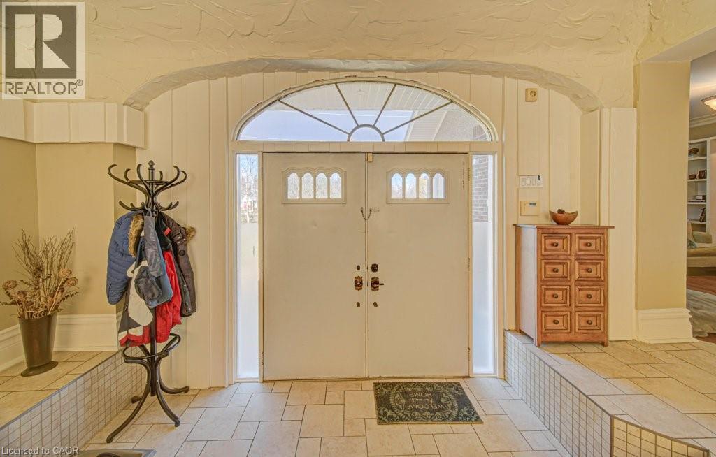 Double entry doors with transom window and sidelights, featuring decorative glass inserts - 2032 Coronation Boulevard, Cambridge, ON - Indoor Photo Showing Other Room