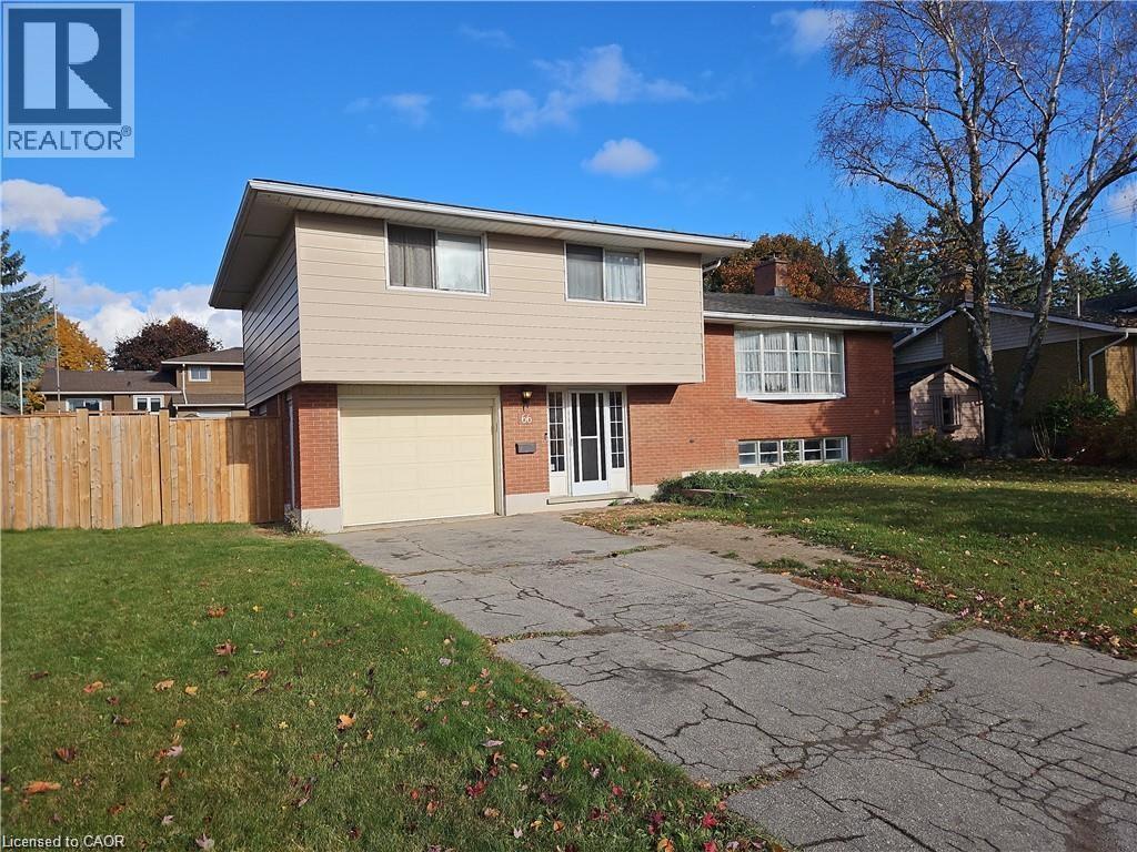 Split-level residence featuring a brick and siding exterior, single-car garage, and a fenced side yard - 66 Summit Avenue, Kitchener, ON - Outdoor