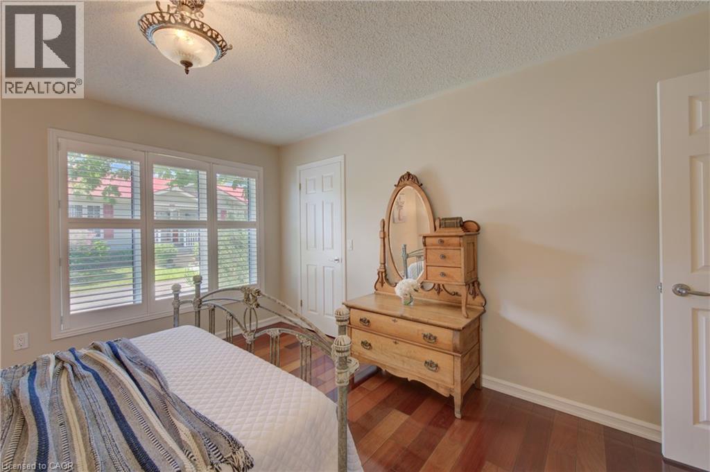 Interior space featuring wood-finish flooring, light-colored walls, and a ceiling light fixture - 137 Wesley Crescent, Waterloo, ON