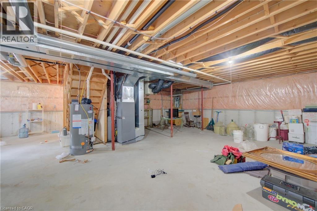 Unfinished basement with concrete flooring and exposed ceiling joists - 137 Wesley Crescent, Waterloo, ON