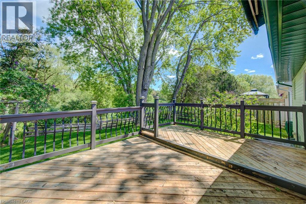 Expansive wooden deck featuring dark-stained railings with decorative balusters - 137 Wesley Crescent, Waterloo, ON