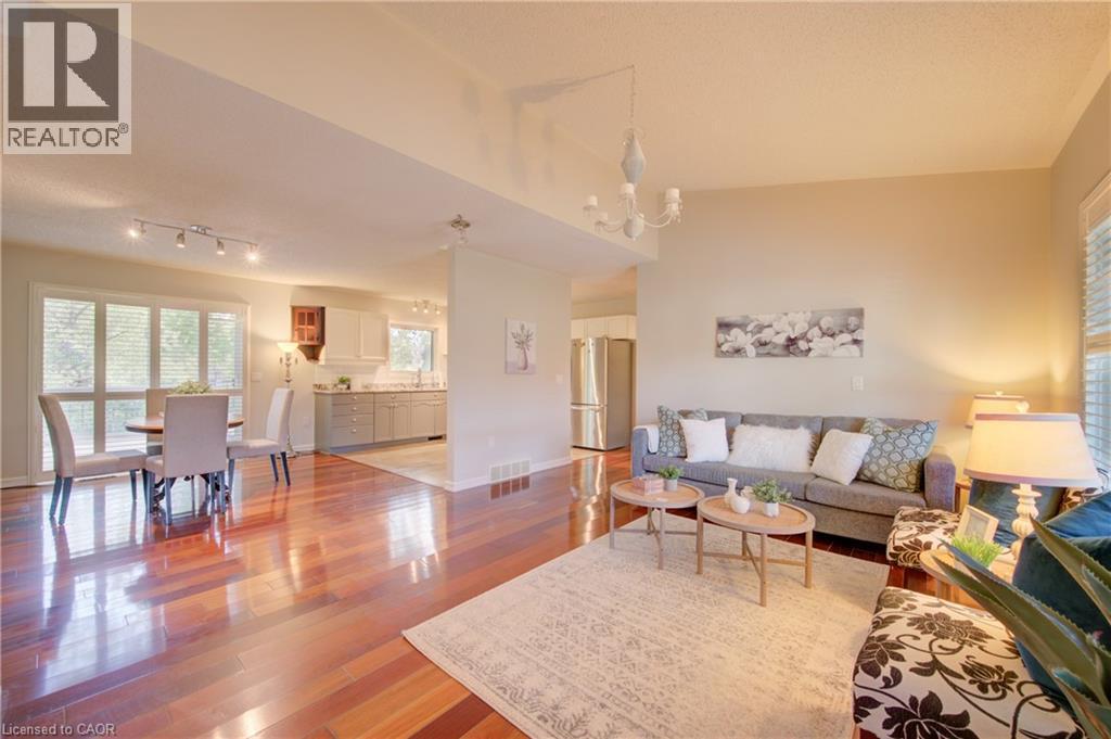 Open-concept living area with lustrous wood-finish flooring - 137 Wesley Crescent, Waterloo, ON