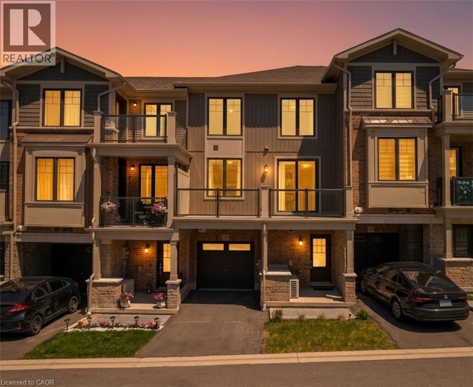 Modern townhome exterior featuring brick and siding finishes - 10 Birmingham Drive Unit# 129, Cambridge, ON - Outdoor With Balcony With Facade