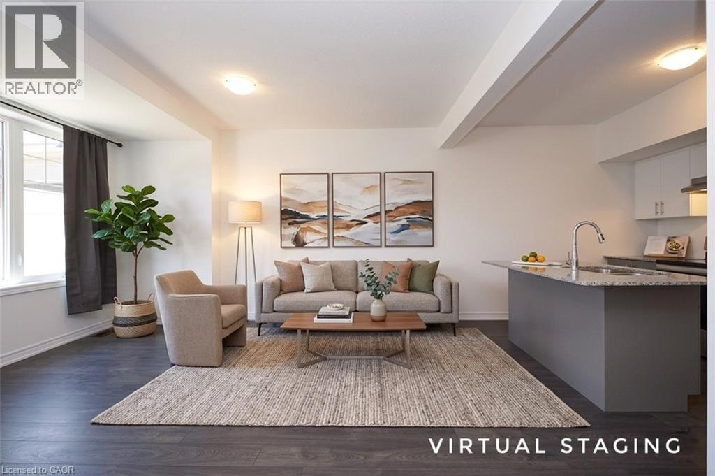 Open-concept living space featuring dark wood-finish flooring, white walls, and recessed lighting - 10 Birmingham Drive Unit# 129, Cambridge, ON - Indoor Photo Showing Living Room