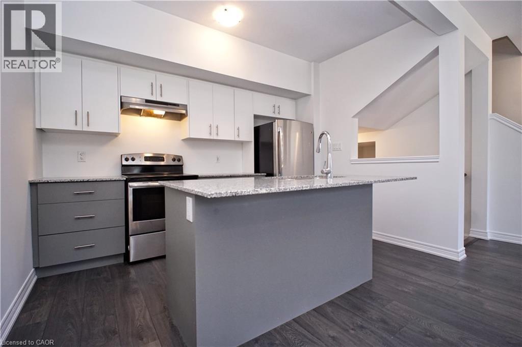 Modern kitchen featuring white upper cabinetry and grey base cabinetry - 10 Birmingham Drive Unit# 129, Cambridge, ON - Indoor Photo Showing Kitchen With Stainless Steel Kitchen With Upgraded Kitchen