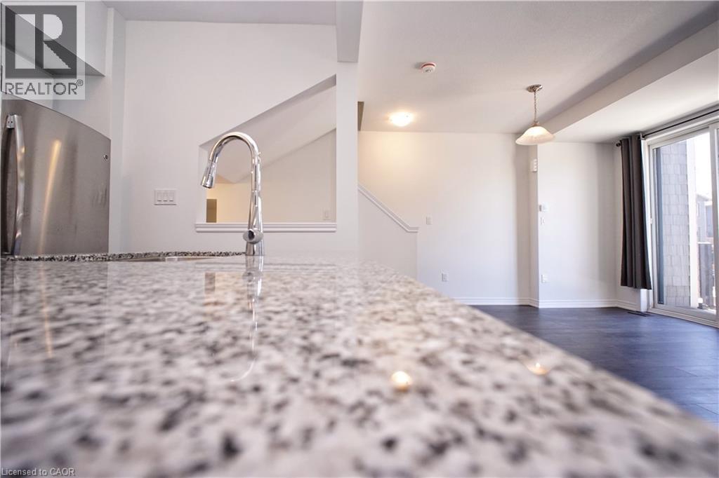 Polished countertop with integrated sink and contemporary chrome faucet - 10 Birmingham Drive Unit# 129, Cambridge, ON - Indoor