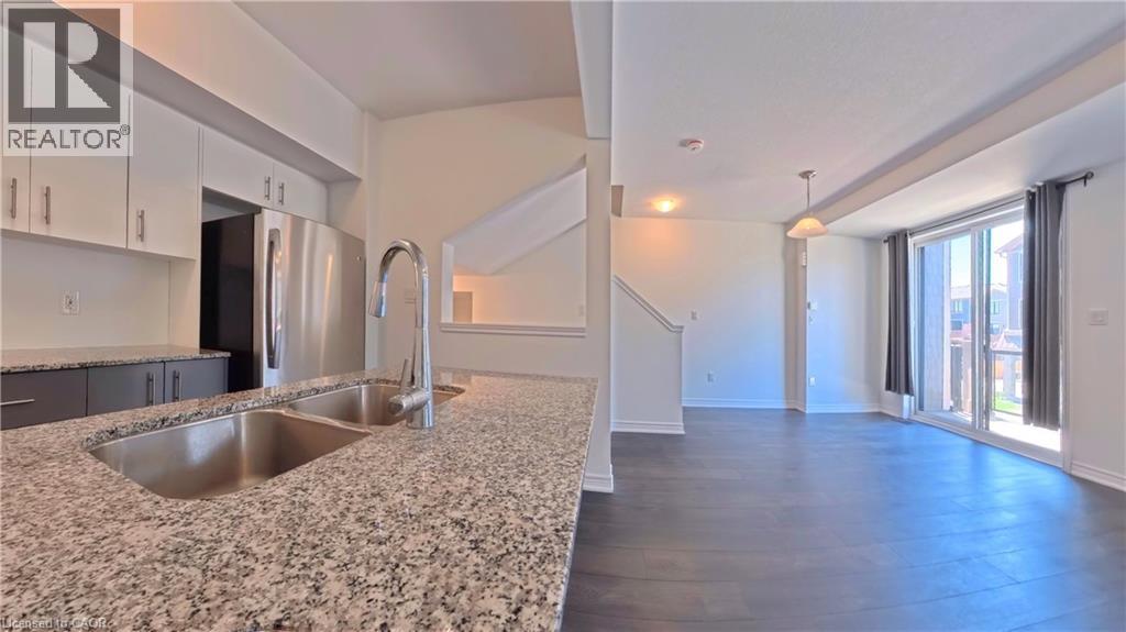 Kitchen featuring granite countertops, undermount double-basin sink, and stainless steel appliances - 10 Birmingham Drive Unit# 129, Cambridge, ON - Indoor Photo Showing Kitchen With Double Sink