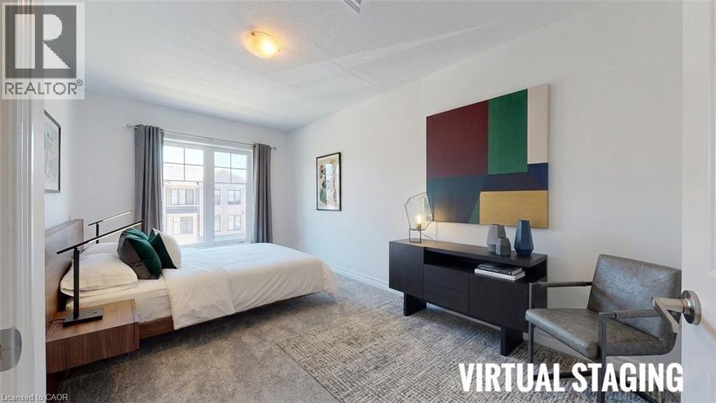 Spacious room featuring a large window with grey drapes, light-toned walls, and a textured area rug - 10 Birmingham Drive Unit# 129, Cambridge, ON - Indoor Photo Showing Bedroom