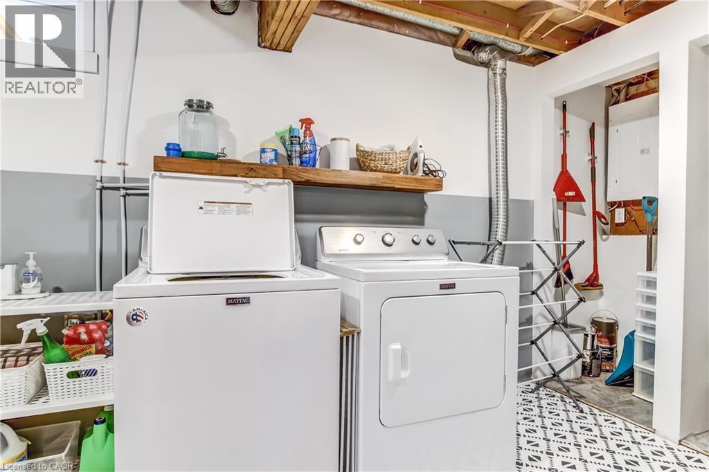 Laundry area featuring a top-load washing machine and front-load dryer - 218 Richardson Drive Unit# 26, Port Dover, ON