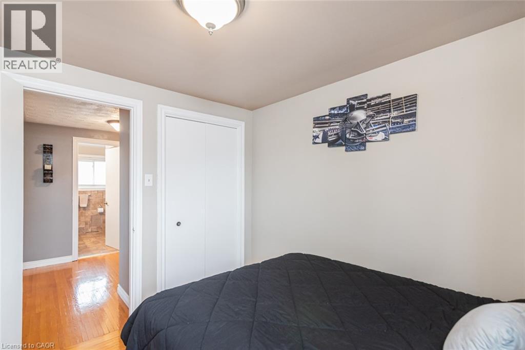 Bedroom featuring light-toned wall paint and a flush-mount ceiling light - 366 Berkindale Drive, Hamilton, ON