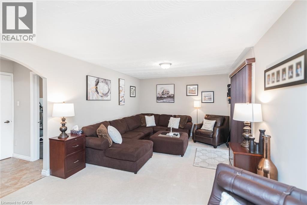 Spacious living area featuring light-toned carpeting and neutral wall tones - 366 Berkindale Drive, Hamilton, ON
