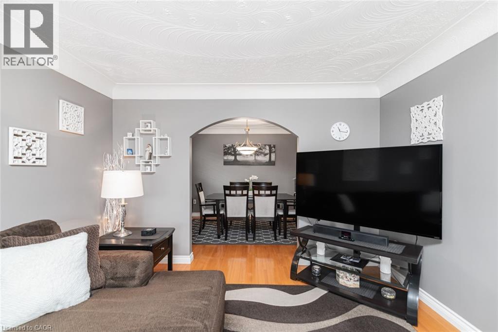 Living space with light gray walls and wood-finish flooring - 366 Berkindale Drive, Hamilton, ON