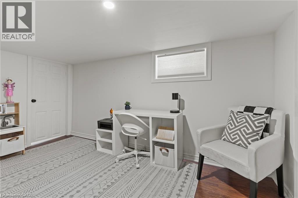 Finished room with recessed lighting and warm-toned wood-finish flooring - 33 Huxley Avenue N, Hamilton, ON