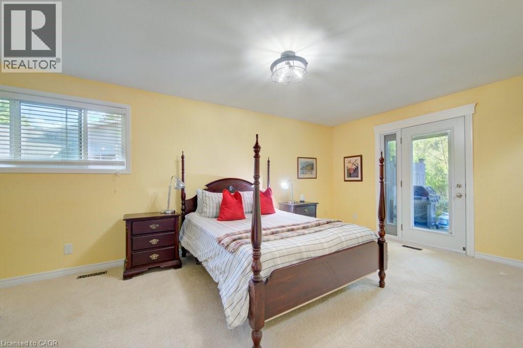 Carpeted room with a large window and double glass doors - 60 Mayfield Avenue, Waterloo, ON